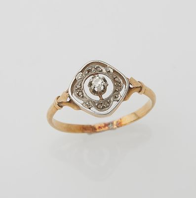 a gold ring with a diamond set in the center