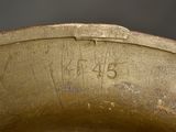 a close up of a gold vase with writing on it