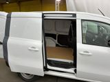 a white van with its doors open in a garage
