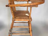 a wooden high chair with a tray on top of it