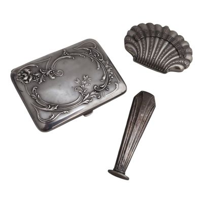 an image of a silver box with a spoon and spoon rest
