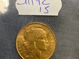 a close up of a gold coin with a label on it