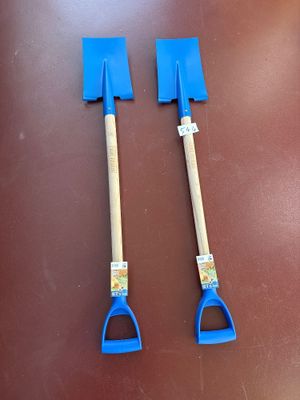 two shovels that are sitting on a table