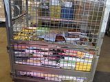 a metal cage filled with assorted items in a warehouse