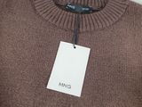 a close up of a brown sweater with a tag on it
