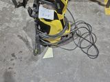 an image of a yellow and black power washer in a garage