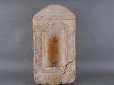 a stone block with a window in it on a gray surface
