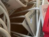 a pile of chairs and umbrellas that are stacked together
