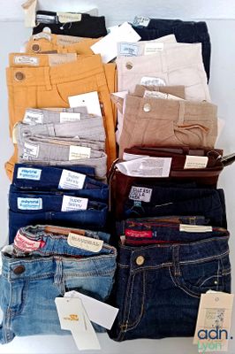 several pairs of jeans are stacked on top of each other