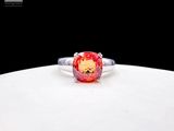 an image of a ring with a red stone on it