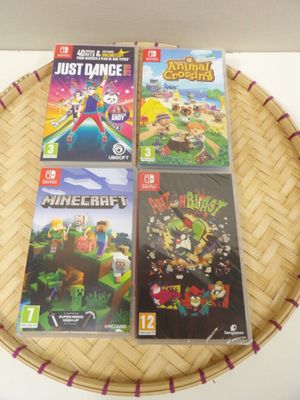three nintendo wii games sitting on top of a basket on a table