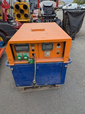 an orange and blue machine sitting on top of a parking lot