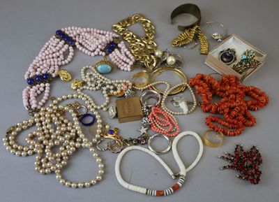 many different types of necklaces and bracelets laid out on a table