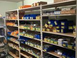 a room with shelves and bins of food in it