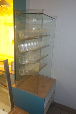 a glass display case in the corner of a room
