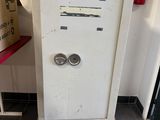 a refrigerator that is sitting in the corner of a room