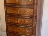 an antique chest of drawers in a room with wood flooring