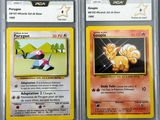 two pokemon cards with different designs on them on a table