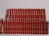 a lot of red books stacked on top of each other