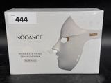a box with a white mask on it on a table