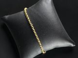 a black pillow with a gold chain on it