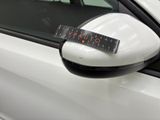 a sticker on the side mirror of a white car