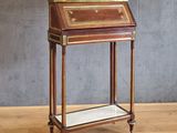an antique writing desk with a marble top on a wooden floor