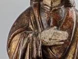 statue of a man with a beard and a robe holding a book