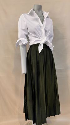 a mannequin wearing a white shirt and green skirt
