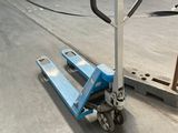 a blue hand truck that is parked in a warehouse