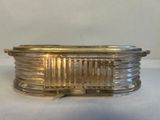 a glass box with a gold lid sitting on a table
