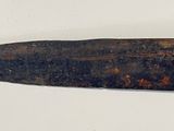 a knife that is laying on a white surface