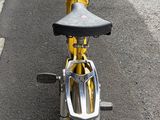 a yellow motorcycle parked on the side of the road