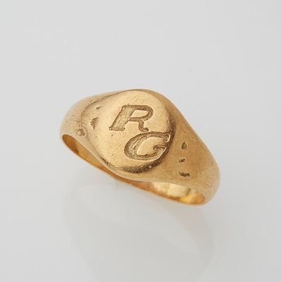 an image of a gold signet ring with the letter r on it