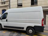 a white van that is parked on the side of the street