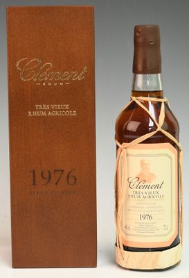 a bottle of whisky sitting next to a wooden box