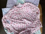 a pile of baby clothes sitting on top of a box