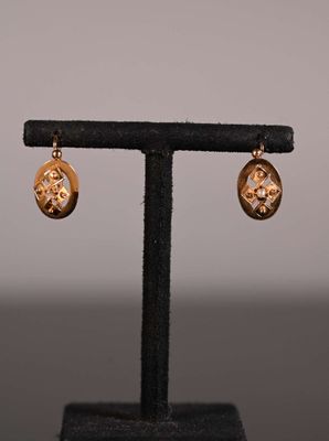 gros plan d'une paire de boucles d'oreilles sur un support