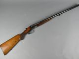 a rifle with a wooden handle and a wooden barrel