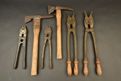 several old tools are lined up on a table