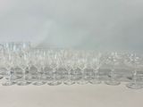 many wine glasses and a decanter sitting on a table