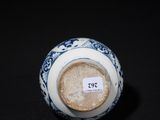 a small blue and white vase with a label on it