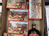 un carton contenant une bouteille d'alcool et une boîte de livres