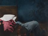 a man that is laying on a bed with a pillow