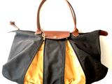 a black and yellow handbag with a brown handle