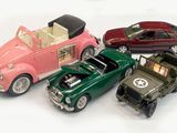 several toy cars are lined up in a row on a white surface