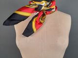 a mannequin torso with a red and yellow scarf on it