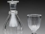 two wine glasses and a decanter sitting next to each other