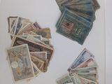 a lot of money sitting on a table next to a laptop