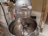 a large metal bowl with a whisk inside of it